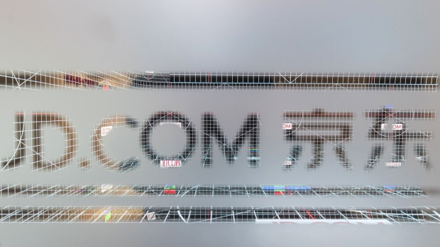 The logo for JD.com Inc. is displayed on a pane of glass at the company's headquarters in Beijing, China, on Monday, Oct. 23, 2017. JD.com is China's second-largest online mall. Photographer: Qilai Shen/Bloomberg
