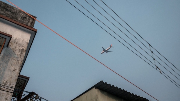 An Air India Ltd. aircraft takes off from Netaji Subhas Chandra Bose International Airport in Kolkata, India, on Sunday, Dec. 6, 2020. Covid-19 has put the sprawling Tata Sons Ltd., which owns a 51% stake in each of AirAsia India and Vistara, at a crossroads. Either go big, by buying state-run Air India for example, or bow out before spilling more red ink. Photographer: Arko Datto/Bloomberg