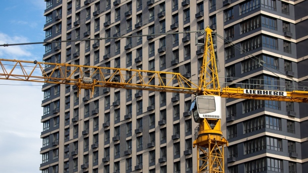 A construction crane stand near residential apartments in Moscow, Russia, on Wednesday, Sept. 30, 2020. Moscow Mayor Sergei Sobyanin over the weekend requested businesses to allow more employees work from home. Photographer: Andrey Rudakov/Bloomberg