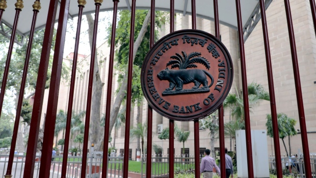 The Reserve Bank of India (RBI) logo is displayed on a gate outside the central bank's regional headquarters in New Delhi, India, on Monday, July 8, 2019. India's central bank governor Shaktikanta Das praised the federal government’s efforts to rein in the fiscal deficit, saying it would help avoid crowding out private investment.
