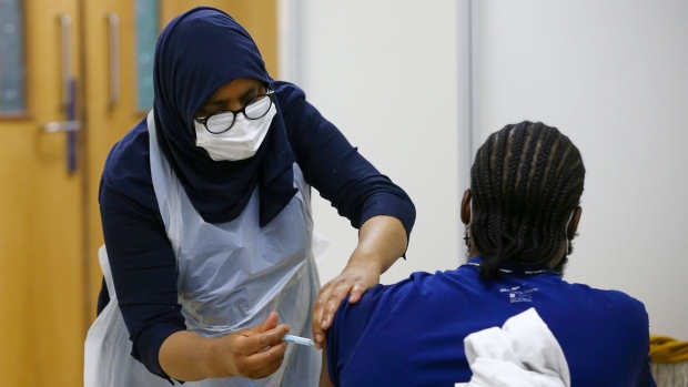A visitor receives a dose of the AstraZeneca Plc Covid-19 vaccine at Central Mosque of Brent in the Willesden Green district of London, U.K., on Friday, March 19, 2021. Skepticism and misinformation are hampering efforts to protect the U.K.'s most diverse and deprived communities.