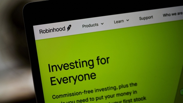 The Robinhood website home screen on a laptop computer arranged in the Brooklyn borough of New York, U.S., on Saturday, Dec. 19, 2020. Robinhood Markets will pay $65 million to settle allegations that it failed to properly inform clients it sold their stock orders to high-frequency traders and other firms, putting a major compliance headache behind the brokerage even as new ones emerge. Photographer: Bloomberg/Bloomberg