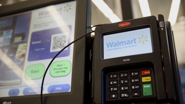 The Wal-Mart Stores Inc. logo is displayed on a self-checkout kiosk at the company's location in Burbank, California, U.S., on Tuesday, Nov. 22, 2016. Consumer hardline retailers are hopeful Black Friday will provide a strong start to the holiday shopping season, but any lift may come at the expense of margins, as the landscape has become increasingly promotional. Photographer: Patrick T. Fallon/Bloomberg