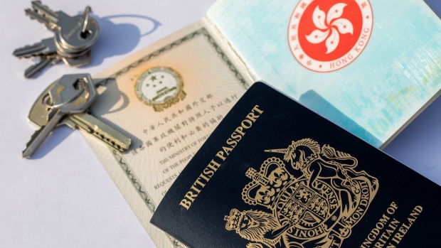 A copy of the British National (Overseas) passport, top, with Hong Kong Special Administrative Region (HKSAR) passport arranged in Hong Kong, China, on Saturday, Jan. 30, 2021. Prime Minister Boris Johnson estimates about 300,000 Hong Kong citizens will take advantage of a new visa route to leave the former British colony and settle in the U.K., despite nearly three million people being eligible.