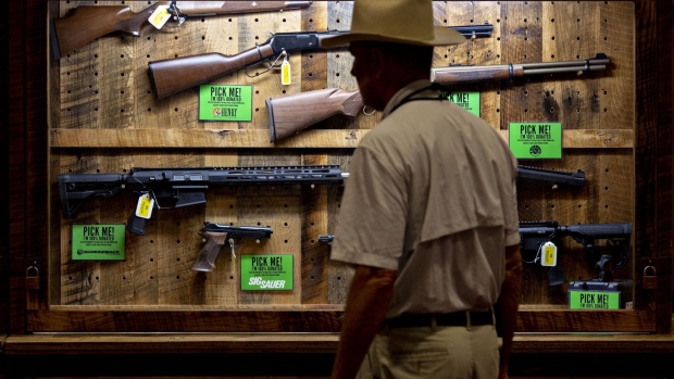 An attendee looks over a display case of guns being raffled ahead of the National Rifle Association (NRA) annual meeting at the Indiana Convention Center in Indianapolis, Indiana U.S., on Thursday, April 25, 2019. President Donald Trump will speak at the NRA Institute for Legislative Action (NRA-ILA) Leadership Forum on Friday. Photographer: Daniel Acker/Bloomberg