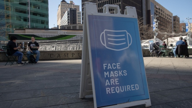 A sign requiring visitors to wear face masks in central Detroit as Michigan becomes a virus epicenter. Photographer: Emily Elconin/Bloomberg