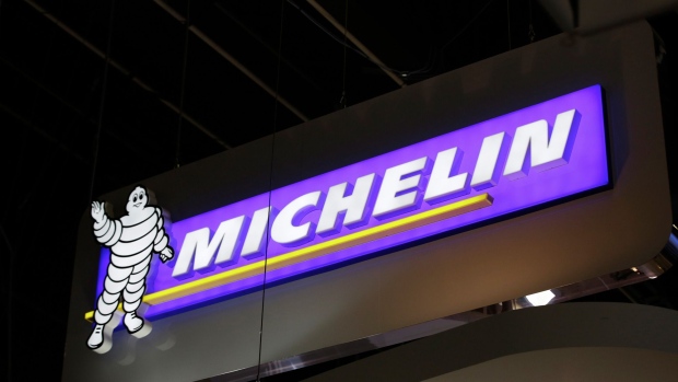 A Michelin logo sits illuminated above a display of aviation tires at the Michelin chalet on day two of the 51st International Paris Air Show in Paris, France, on Tuesday, June 16, 2015. The 51st International Paris Air Show is the world's largest aviation and space industry exhibition and takes place at Le Bourget airport June 15 - 21. Photographer: Bloomberg/Bloomberg