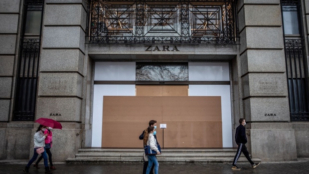 Pedestrians pass a boarded-up closed Zara clothing store, operated by Inditex SA, in Barcelona, Spain, on Monday, March 8, 2021. Inditex will report its annual results on Wednesday.