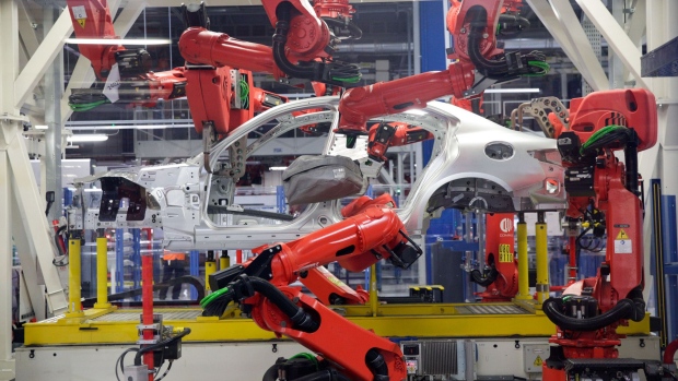 Robotics arms, manufactured by Comau SpA, work on an Alfa Romeo Giulia automobile on the production line at Fiat Chrysler Automobiles NV's Alfa Romeo assembly plant in Cassino, Italy, on Thursday, Nov. 24, 2016. President-elect Donald Trump's critical stance toward free trade could affect Fiat Chrysler Automobiles NV's business in North America, according to the Italian automaker's chief executive officer Sergio Marchionne. Photographer: Matthew Lloyd/Bloomberg