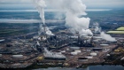 Steam rises from the Syncrude Canada Ltd. upgrader plant in this aerial photograph taken above the Athabasca oil sands near Fort McMurray, Alberta, Canada, on Monday, Sept. 10, 2018. While the upfront spending on a mine tends to be costlier than developing more common oil-sands wells, their decades-long lifespans can make them lucrative in the future for companies willing to wait. Photographer: Ben Nelms/Bloomberg