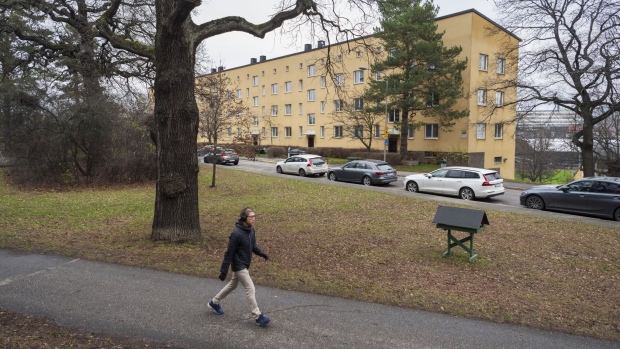 A pedestrian passes near a Barnrikehus at Onkel Adams Vag in Stockholm, Sweden, on Monday, Dec. 7, 2020. The Barnrikehus, or “child-rich house”, municipally-built 1930s housing blocks that ring inner Stockholm are in high demand.