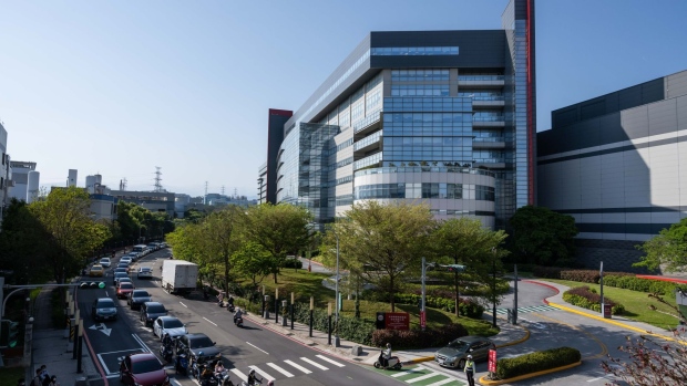 Vehicle travels past the Taiwan Semiconductor Manufacturing Co. headquarters in Hsinchu, Taiwan, on Wednesday, April 7, 2021. The TSMC is a key supplier to Apple, and it’s the iPhone maker’s commitment to become carbon neutral by 2030 that is driving much of the change throughout the supply chain.