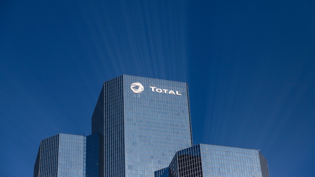 A logo sits on the exterior of the Total SA skyscraper headquarters in the La Defense business district in Paris, France, on Wednesday, Jan. 22, 2020. French Finance Minister Bruno Le Maire said he’s hopeful for a compromise with the U.S. on digital tax to avoid a transatlantic trade war. Photographer: Anita Pouchard Serra/Bloomberg