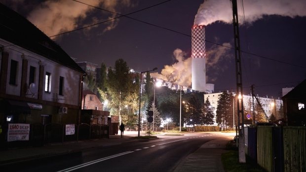 Emissions rise from chimneys at the Turow coal powered power plant, operated by PGE SA, at night in Bogatynia, Poland, on Tuesday, Sept. 29, 2020. Poland may finally be on the path to set the end-date for its unprofitable coal industry as an agreement with mining unions is within sight.