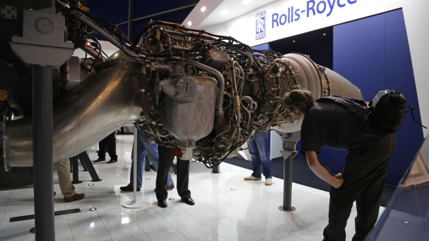 A visitor inspects the mechanics of a Rolls-Royce TP400-D6 aircraft engine at the air show.