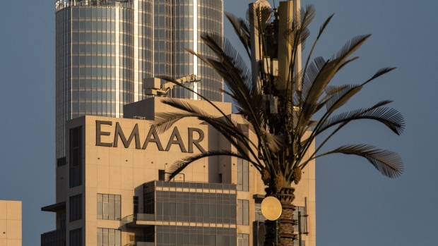 The logo of Emaar Properties PJSC sits on display on the top of a building near the Burj Khalifa skyscraper in Dubai, United Arab Emirates, on Monday, Oct. 12, 2020. Dubai real estate stocks were once the stars for investors betting on the city’s booming economy. But their fall from grace has been spectacular and seems set to continue, given an abundance of unsold homes and scant prospects for a recovery in the oil-rich region. Photographer: Christopher Pike/Bloomberg