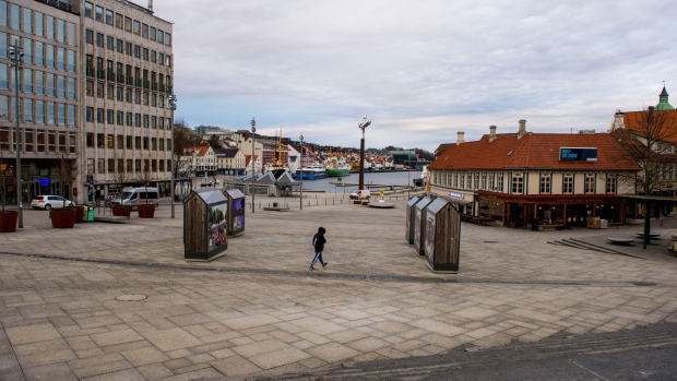 A single pedestrian walks near the quayside in Stavanger, Norway, on Wednesday, Feb. 17, 2021. The Norwegian krone has become the best performing G10 currency in the year to date. Photographer: Carina Johansen/Bloomberg