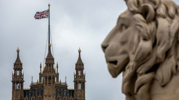 A statue of a Lion stands on Westminster Bridge in the view of the Houses of Parliament in London, U.K., on Tuesday, Oct. 13, 2020. U.K. Prime Minister Boris Johnson announced bars and pubs will be closed in the worst-hit parts of England from Wednesday to control a surge in coronavirus, but his top health adviser said it won’t be enough.