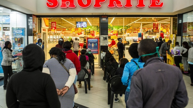 Residents queue to receive their South African Social Security Agency (SASSA) grant payment at Alex Shopping Mall in the Alexandra township of Johannesburg, South Africa, on Friday, June 5, 2020. While central banks and governments in North America, Asia and Europe have offered trillions of dollars to prop up businesses hit by lockdowns and provide a safety net for the swelling ranks of the unemployed, a lack of liquidity restricts African governments from providing similar relief. Photographer: Waldo Swiegers/Bloomberg