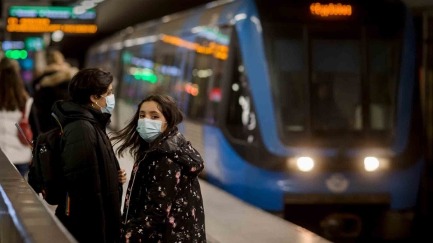 STOCKHOLM, SWEDEN - MARCH 01: A mother and daughter practice the government's call to wear a face mask on public transport on March 1, 2021 in Stockholm, Sweden. A surge of Covid-19 infections has prompted Sweden to gradually abandon its unique approach of voluntary measures. New restrictions as of March 1st aim to curb the rise in coronavirus cases, as the country of 10 million inhabitants reports some 657, 000 infection cases. (Photo by Jonas Gratzer/Getty Images) Photographer: Jonas Gratzer/Getty Images Europe
