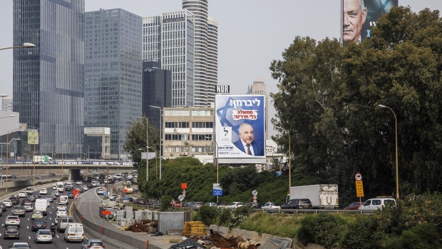 Election campaign billboards for Avigdor Liberman, leader of the Yisrael Beitenu party, left and Benny Gantz, Israels defense minister and leader of the Blue and White party, alongside a highway in Tel Aviv, Israel, on Monday, March 15, 2021. Israel's holding parliamentary elections for the fourth time in two years on March 23. Photographer: Bloomberg/Bloomberg