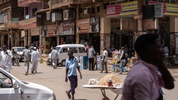 Pedestrians walk down a main street in Khartoum, Sudan.