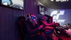 Gamers wear headsets to play the Gran Turismo in Taipei.