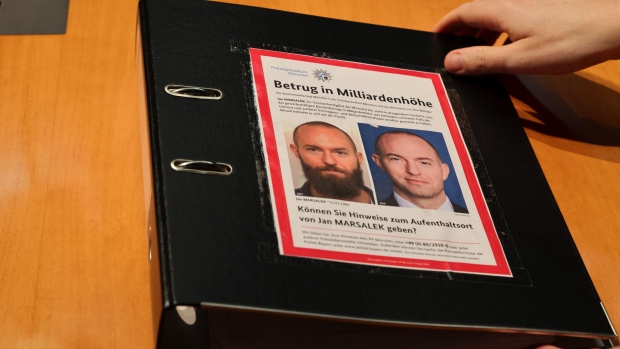 A police wanted poster featuring Jan Marsalek on an inquiry member's folder at the inquiry into the collapse of Wirecard, at the German Bundestag’s Paul-Loebe-Haus in Berlin, on March 18.