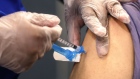 A healthcare worker wearing protective gloves draws a dose of the Moderna Inc. Covid-19 vaccine at a mobile drive-thru vaccination site in Novato, California, U.S., on Wednesday, March 24, 2021. Health departments across the U.S. have deployed mobile units to eliminate challenges like waking up early to schedule appointments, navigating online portals and standing in line, all of which can deter the elderly, disabled or immune-compromised.