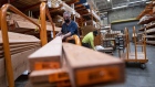 A customer wearing a protective mask loads lumber onto a cart at a Home Depot store in Pleasanton, California, U.S., on Monday, Feb. 22, 2021. Home Depot Inc. is expected to release earnings figures on February 23.