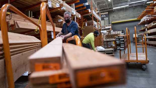 A customer wearing a protective mask loads lumber onto a cart at a Home Depot store in Pleasanton, California, U.S., on Monday, Feb. 22, 2021. Home Depot Inc. is expected to release earnings figures on February 23.