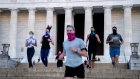 People wear protective masks while exercising at the Lincoln Memorial in Washington, D.C., U.S., on Wednesday, April 21, 2021. Senate Republicans will debate today whether to participate in the new system of earmarking congressional spending, though the outcome likely won't matter to members who are determined to bring funding to their home districts.
