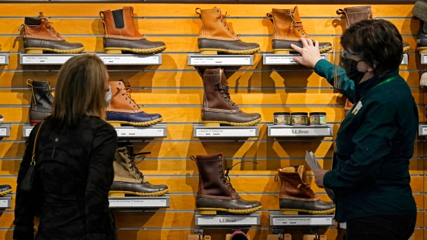 A salesperson helps a customer shopping for Bean Boots at the L.L. Bean flagship retail store.