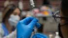 A healthcare worker prepares a dose of the Pfizer-BioNTech Covid-19 vaccine. Photographer: Bing Guan/Bloomberg
