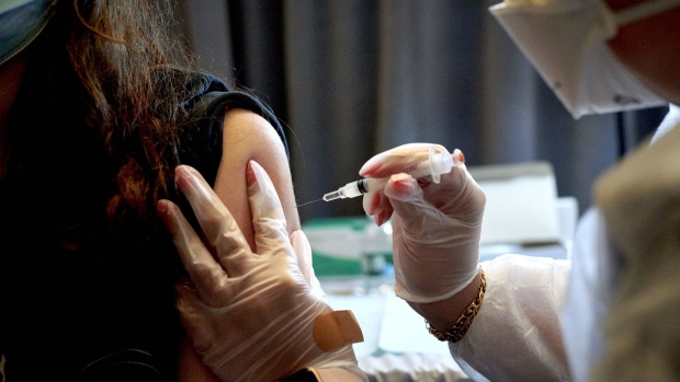 A healthcare worker administers the Moderna Covid-19 vaccine. Photographer: Gabby Jones/Bloomberg