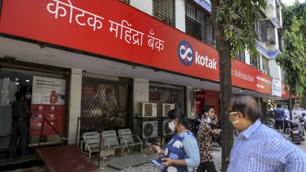 Customers wearing protective masks approach a Kotak Mahindra Bank Ltd. branch on a near-empty street in Mumbai, India, on Monday, May 4, 2020. India's central bank Governor Shaktikanta Das and the chief executive officers of the nation's banks have discussed ways to ensure credit flow to businesses once the world's toughest stay-at-home order ends.