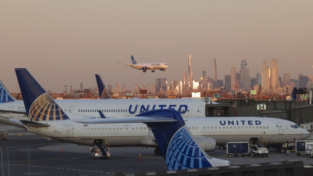An aircraft operated by United Airlines Holdings Inc. lands at Newark Liberty International Airport in Newark, New Jersey, U.S., on Monday, Nov. 16, 2020. From November 16 through December 11, the United Airlines will offer rapid tests to every passenger over 2 years old and crew members on board select flights from Newark Liberty International Airport to London Heathrow, free of charge. Photographer: Angus Mordant/Bloomberg