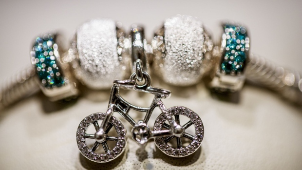 A Brilliant Bicycle Pendant Charm sits on a bracelet on display in a Pandora A/S store in Copenhagen, Denmark, on Monday, Aug. 19, 2019. Pandora, a Danish jewelry company that spent much of last year under attack by hedge funds as it tries to relaunch its brand, reported a smaller decline in operating profit than expected but said its efforts to turn the business around will entail additional costs. Photographer: Carsten Snejbjerg/Bloomberg