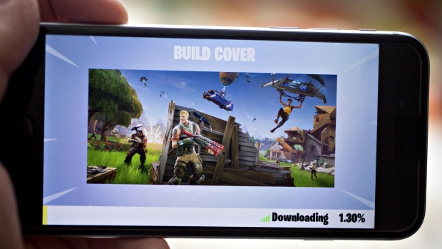 The Epic Games Inc. Fortnite: Battle Royale video game is displayed for a photograph on an Apple Inc. iPhone in Washington, D.C., U.S., on Thursday, May 10, 2018. Fortnite, the hit game that's denting the stock prices of video-game makers after signing up 45 million players, didn't really take off until it became free and a free-for-all. Photographer: Andrew Harrer/Bloomberg