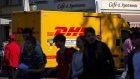 Pedestrians pass a DHL Worldwide Express GmbH delivery truck in Potsdam, Germany, on Thursday, Oct. 1, 2020.