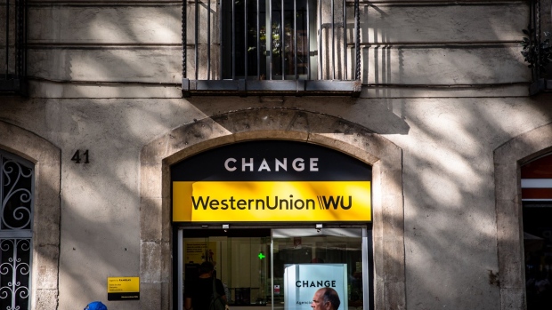A Western Union Co. branded sign stands above the entrance to a currency exchange bureau on Las Ramblas Avenue in Barcelona, Spain, on Wednesday, Sept. 4, 2019. Sterling’s decline has made U.K. travelers even more price sensitive this summer holiday season, pushing some to choose cheaper beach destinations in Turkey, Egypt and Tunisia. Photographer: Angel Garcia/Bloomberg