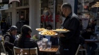 A worker serves food at a restaurant on Pier 39 in San Francisco. Photographer: David Paul Morris/Bloomberg
