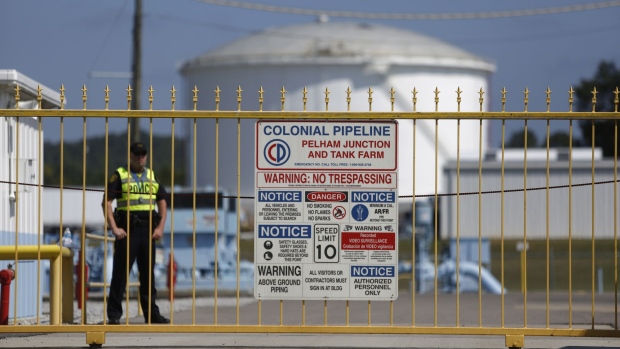 A police officer stands guard inside the gate to the Colonial Pipeline Co. Pelham junction and tank farm in Pelham, Alabama, U.S., on Monday, Sept. 19, 2016. Customers buying gasoline at grocery stores and other independent retailers may pay more than those shopping at name-brand outlets after the biggest gasoline pipeline in the U.S. sprung a leak in Alabama on Sept. 9. Colonial Pipeline Co. has proposed restarting the line on Sept. 22, according to the Alabama Emergency Management Agency.