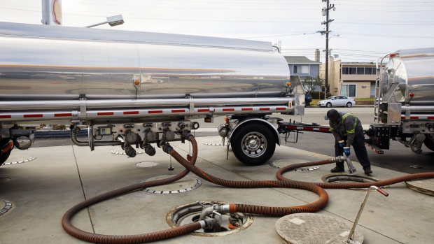 A worker disconnects hoses after delivering gasoline from a fuel tanker truck at a Royal Dutch Shell Plc gas station in Redondo Beach, California, U.S., on Sunday, July 28, 2019. Royal Dutch Shell is scheduled to release earnings figures on August 1. Photographer: Patrick T. Fallon/Bloomberg