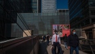 Pedestrians wearing protective face masks walk in the Canary Wharf business, financial and shopping district of London, U.K., on Monday, Sept. 14, 2020. Londoners are steadily increasing their use of public transport after schools reopened, freeing parents to go back to the workplace. Photographer: Simon Dawson/Bloomberg
