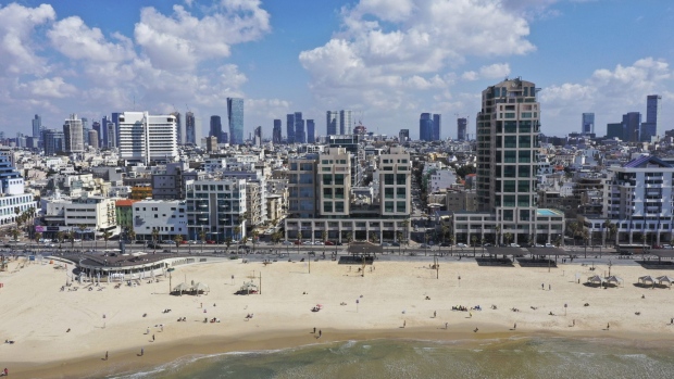 Beachgoers relax on the beach in this aerial photograph taken in Tel Aviv, Israel, on Friday, March 5, 2021. Israel's vaccine campaign raced ahead of the world after the government inked a deal with Pfizer Inc. in exchange for data on the inoculation program.
