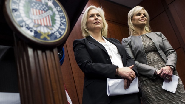 Senator Kirsten Gillibrand, a Democrat from New York, left, and Gretchen Carlson, former host at Fox News Network LLC, listen during a news conference unveiling bipartisan legislation to prevent sexual harassment in the workplace on Capitol Hill in Washington, D.C., U.S., on Wednesday, Dec. 6, 2017. Seven female U.S. senators called on fellow Democrat Al Franken to resign Wednesday following allegations, and his admission in at least one case, that he groped or sexually harassed women. His office said he will make an announcement on Thursday.
