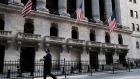 People walk past the New York Stock Exchange (NYSE) in New York. Photographer: Spencer Platt/Getty Images North America
