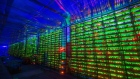 Illuminated mining rigs operate inside racks at the CryptoUniverse cryptocurrency mining farm in Nadvoitsy, Russia, on Thursday, March 18, 2021. The rise of Bitcoin and other cryptocurrencies has prompted the greatest push yet among central banks to develop their own digital currencies.
