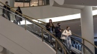 Shoppers wearing protective masks ride an escalator inside the Westfield San Francisco Centre shopping mall in San Francisco, California, U.S., on Tuesday, March 9, 2021. San Francisco Mayor London Breed said indoor dining, movie theaters and gyms can reopen on a limited basis after California moved the region to a less-restrictive tier.